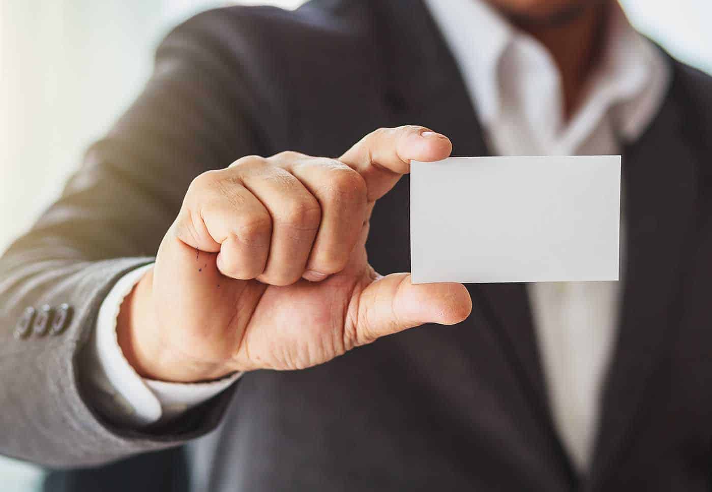 someone holding up a business card