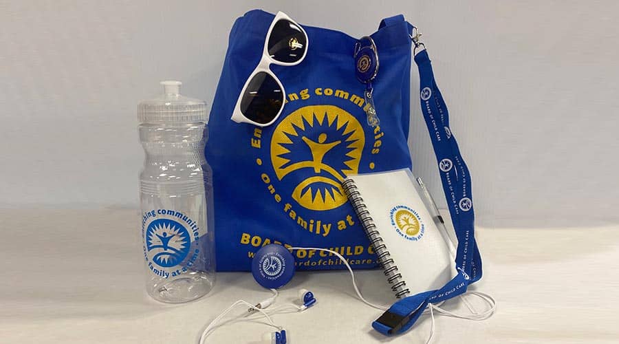 nonprofit branded bag, sunglasses, water bottle, and journal promotional products