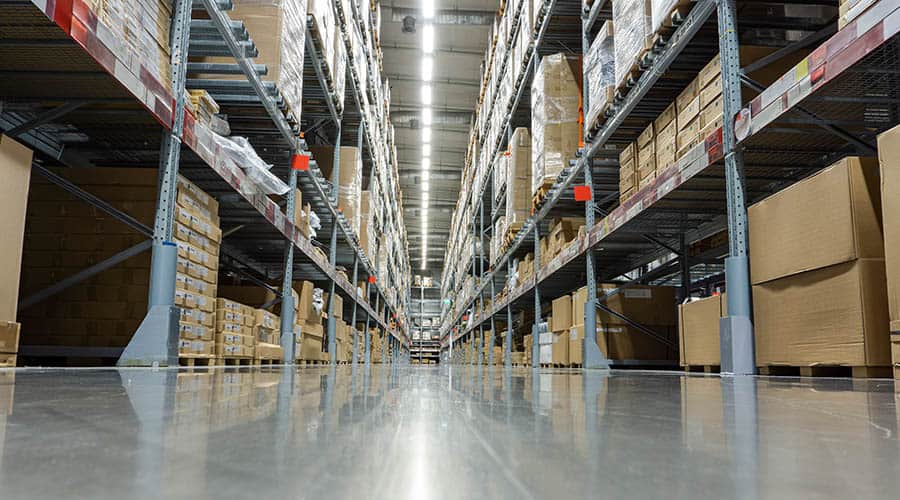storage warehouse aisle holding inventory on pallets
