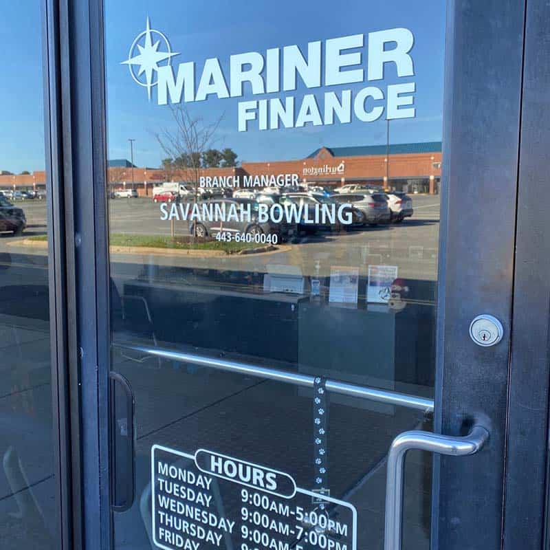 Vinyl glass door decals of Mariner Finance branch location, phone number, and business hours