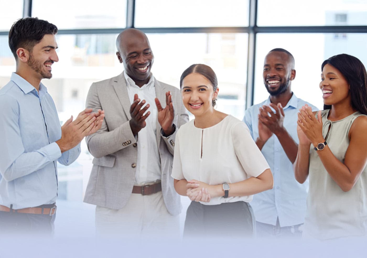 group of corporate employees clapping with appreciation